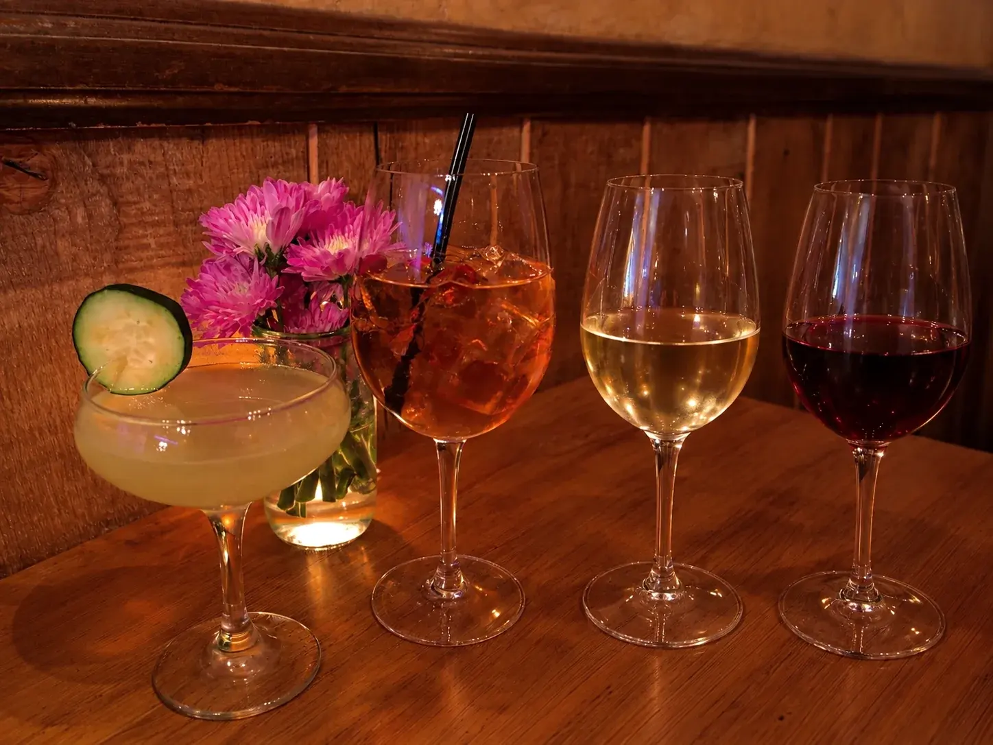 Two cocktails and glasses of white and red wine